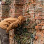 Man interested in the hole.